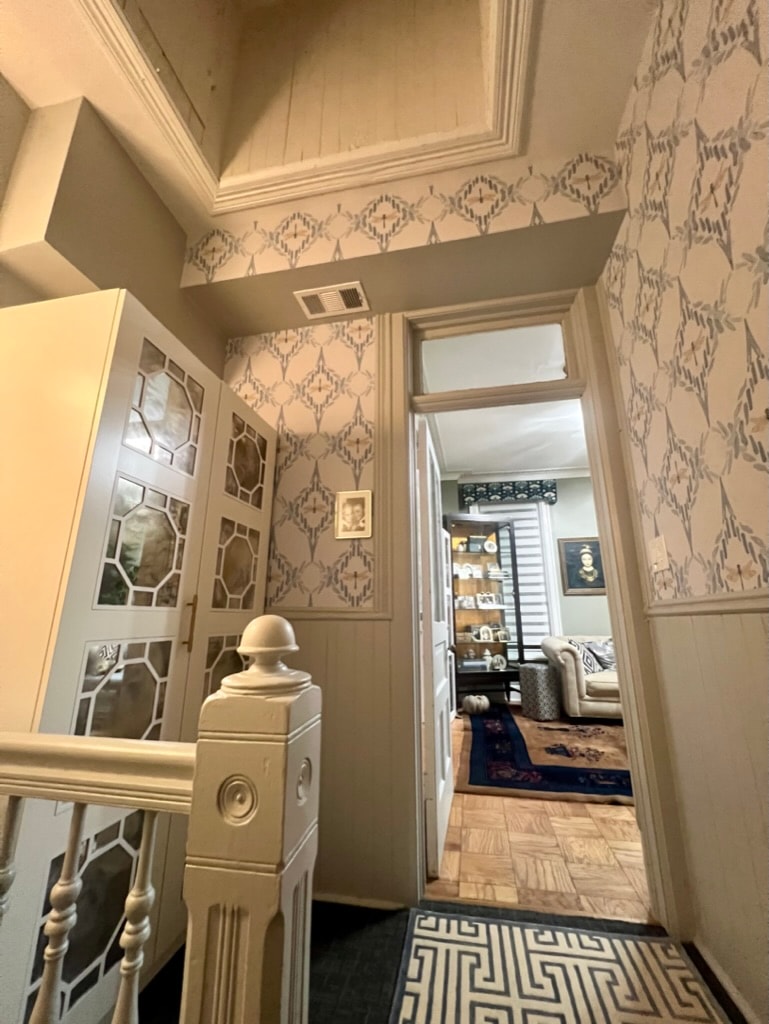 Hallway with patterned wallpaper