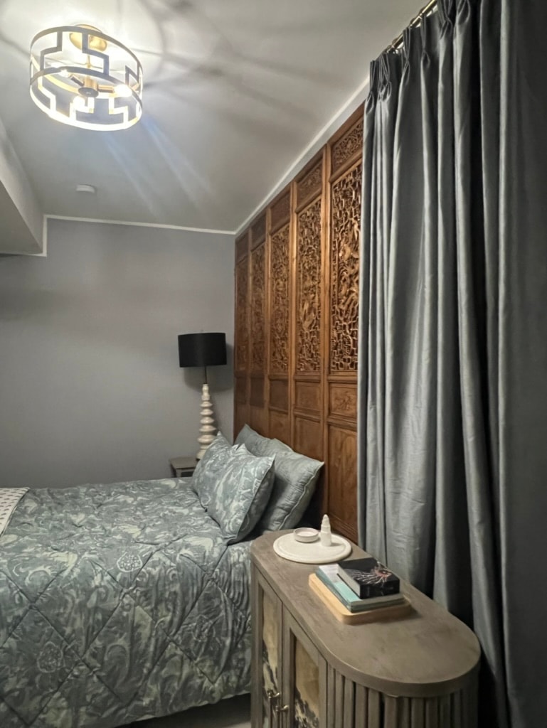 Bedroom with carved wood panels