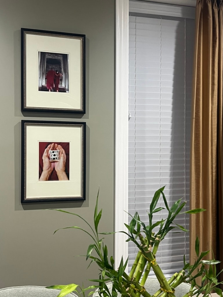 Framed artwork on sage green wall