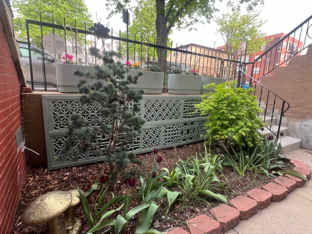 Urban garden with decorative screening and tulips