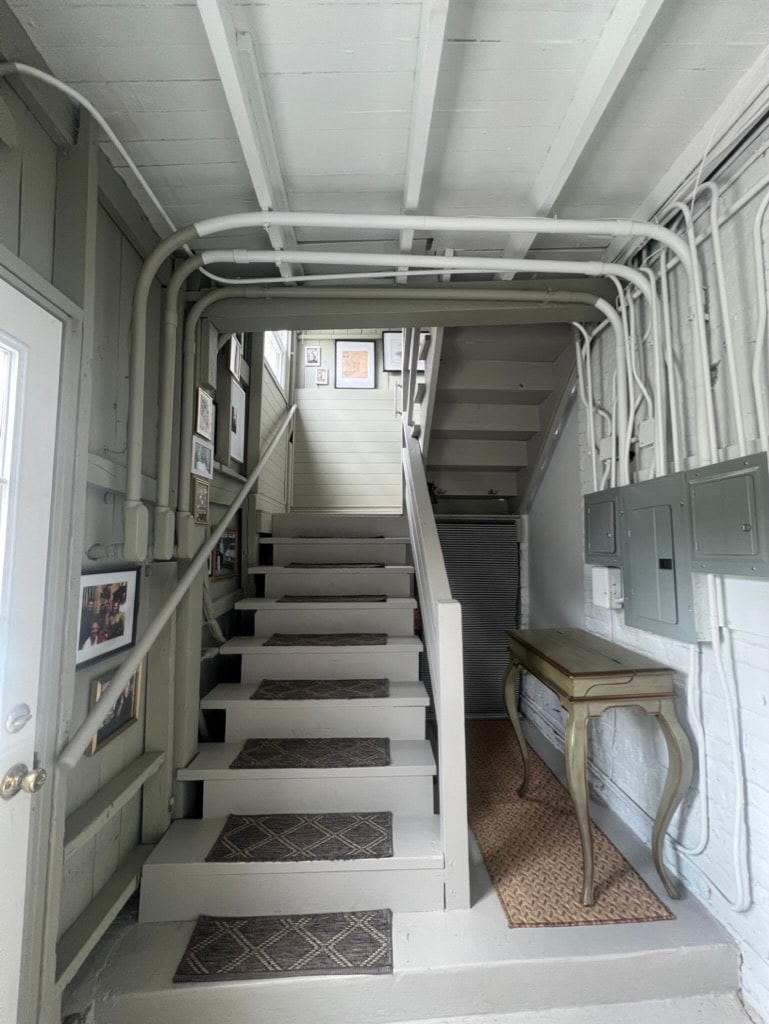 Stairwell with gallery wall and console table